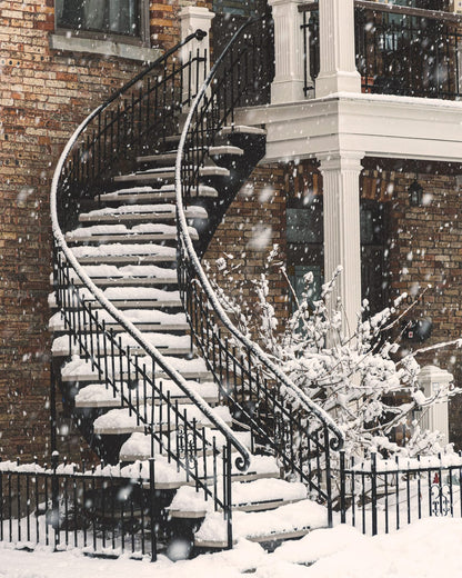 An outdoor staircase covered in snow.