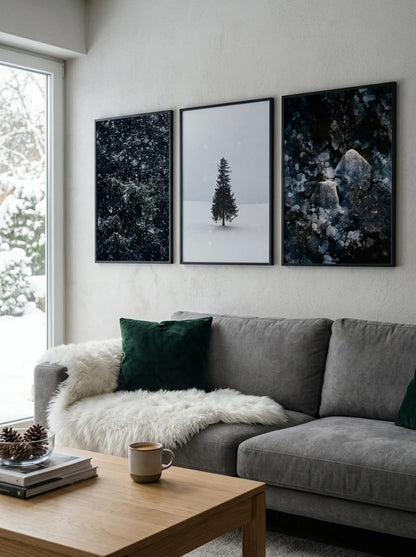 Three winter prints above a gray sofa.