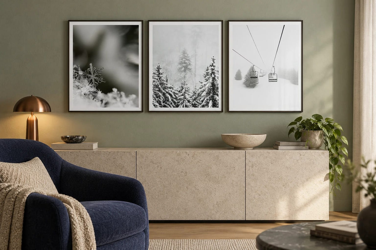 A snowflake and forest print set on a sage wall.