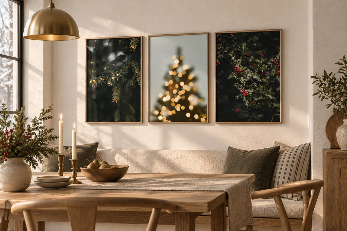 Evergreen and berry prints arranged above a dining table.