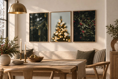 Evergreen and berry prints arranged above a dining table.