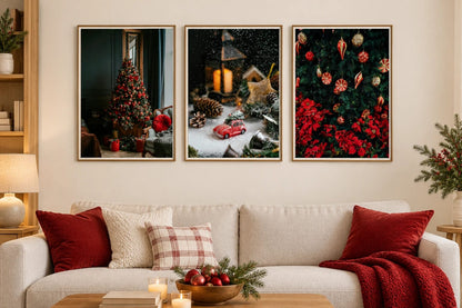 Three holiday prints hang above a light sofa with burgundy pillows.
