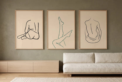 Three figure line drawings displayed on an olive living-room wall.