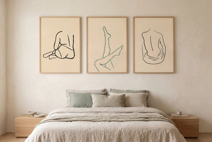 Figure line-art prints displayed above a bed with light linen.