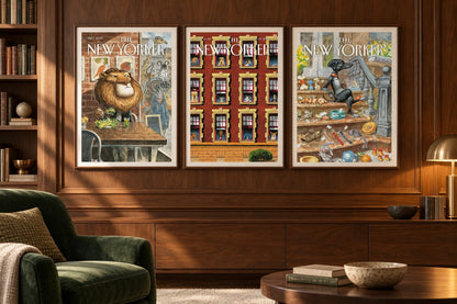Three animal cover prints hang on dark wood paneling beside a green chair.