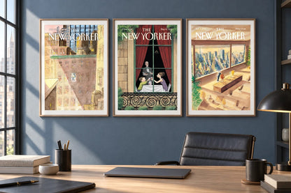 Three framed prints hang on a blue office wall above a desk by a window.