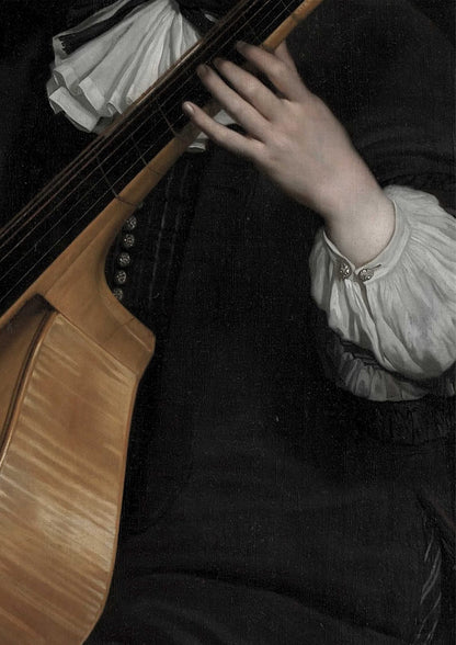 A hand holds a stringed musical instrument.