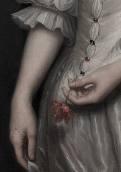 Hands hold a red flower beside a white sleeve.