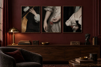 Three dark stage-detail prints hang on a wine-colored wall in a music room.