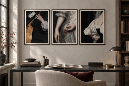 Three stage-detail prints hang above a desk in a light plaster library.