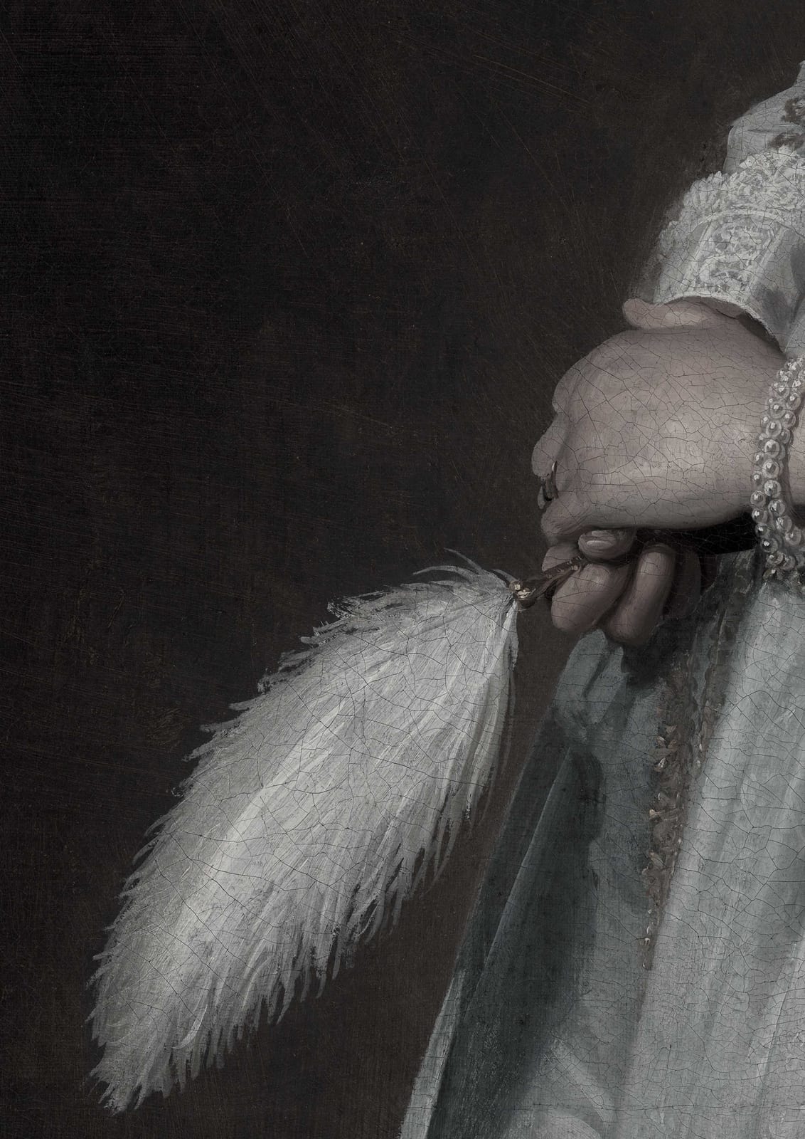 A hand holds a white feather fan.