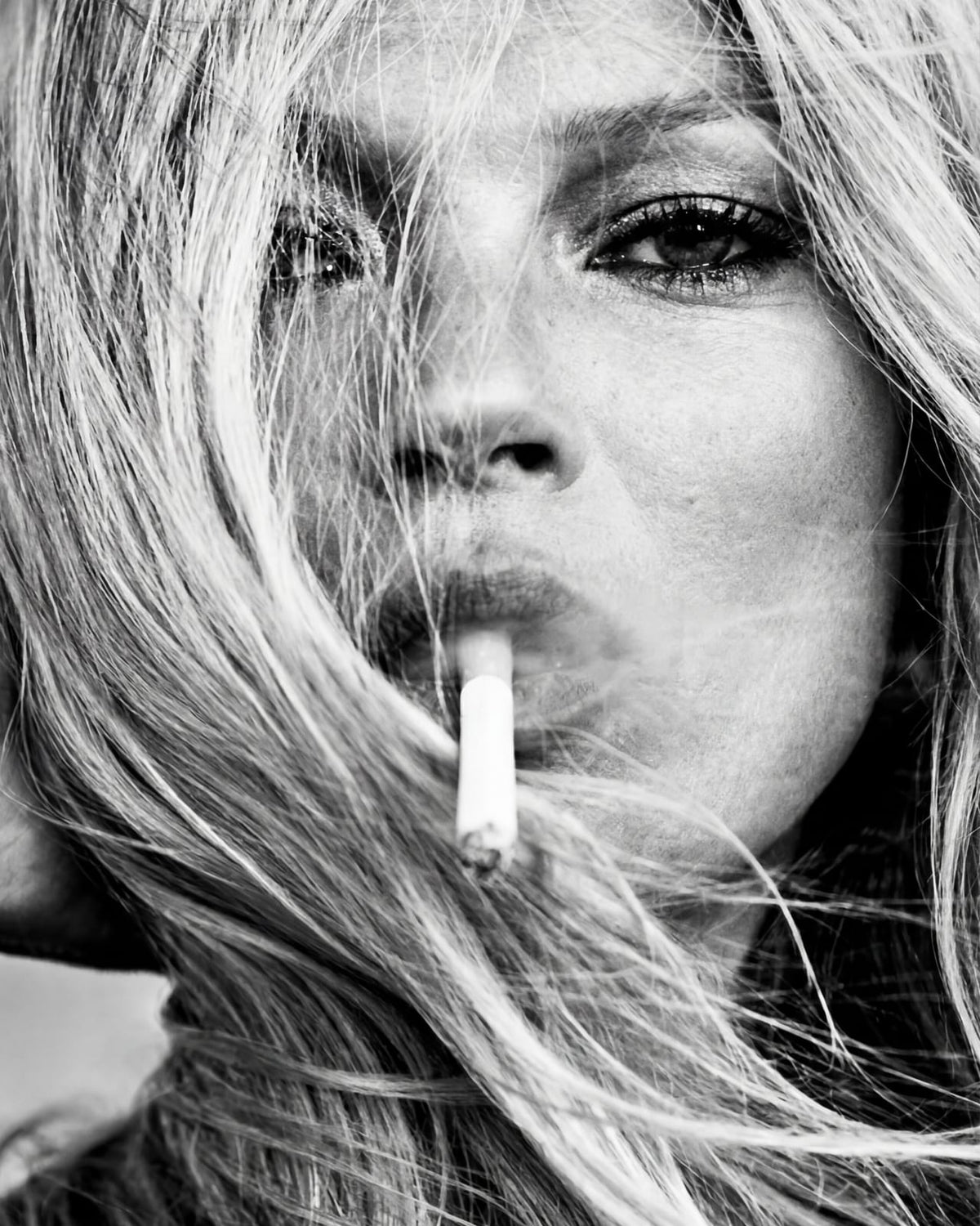 A woman holding a cigarette.