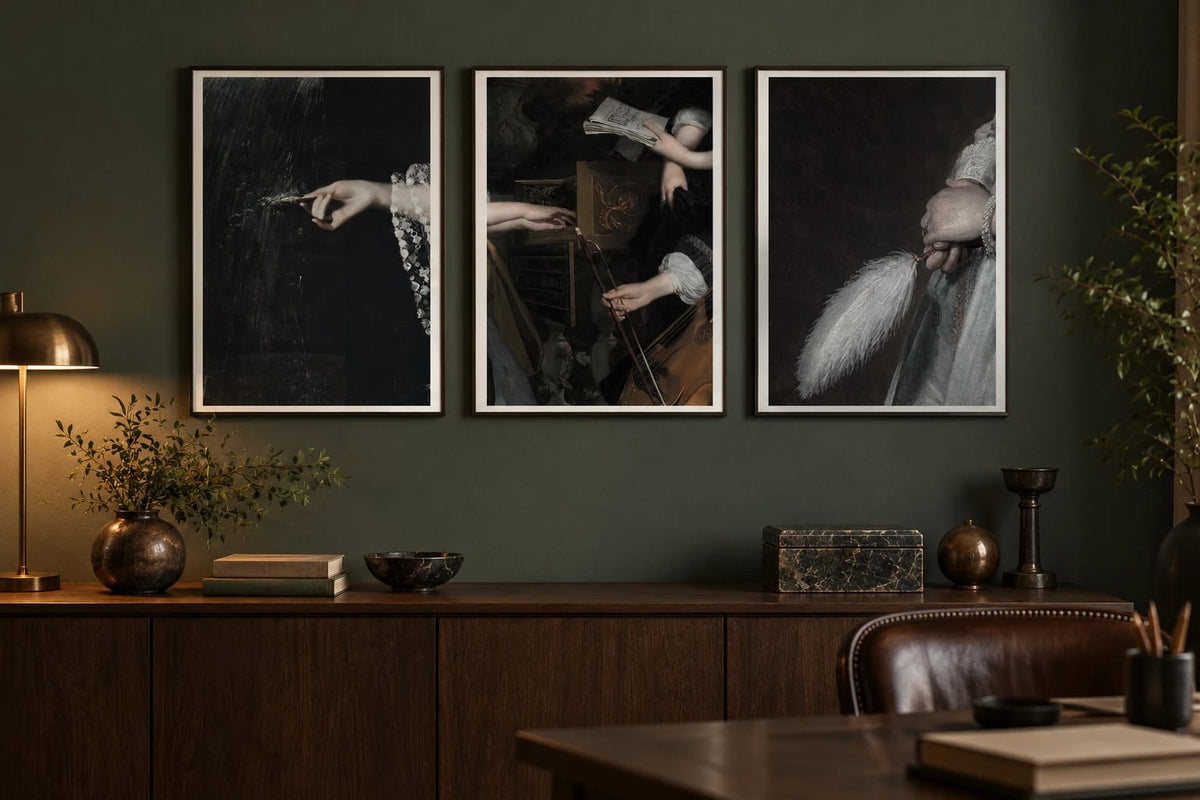 Art-detail prints displayed on a dark-green office wall.