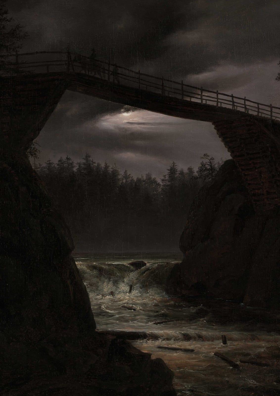 An arched bridge crosses water at night.
