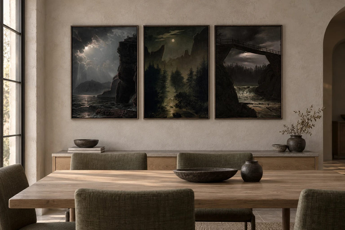 Three night landscapes hang above a wood console on a light stone dining-room wall.