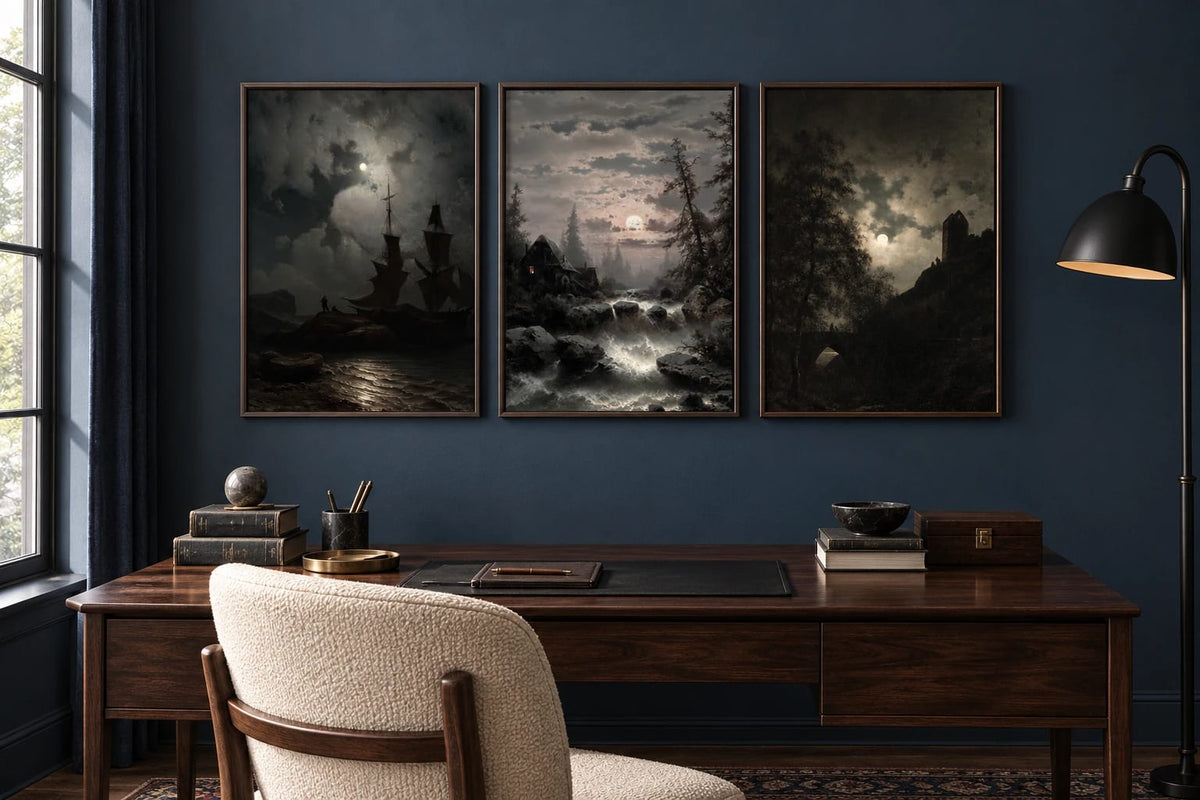 Three night landscapes hang above a large dark desk in a navy office.
