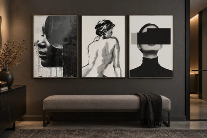 Black-and-gray prints displayed on a graphite wall above a bench.