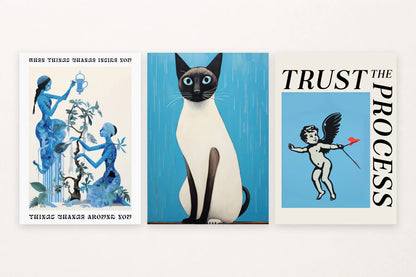 A Siamese cat shares the set with an affirming plant design and cherub figure.