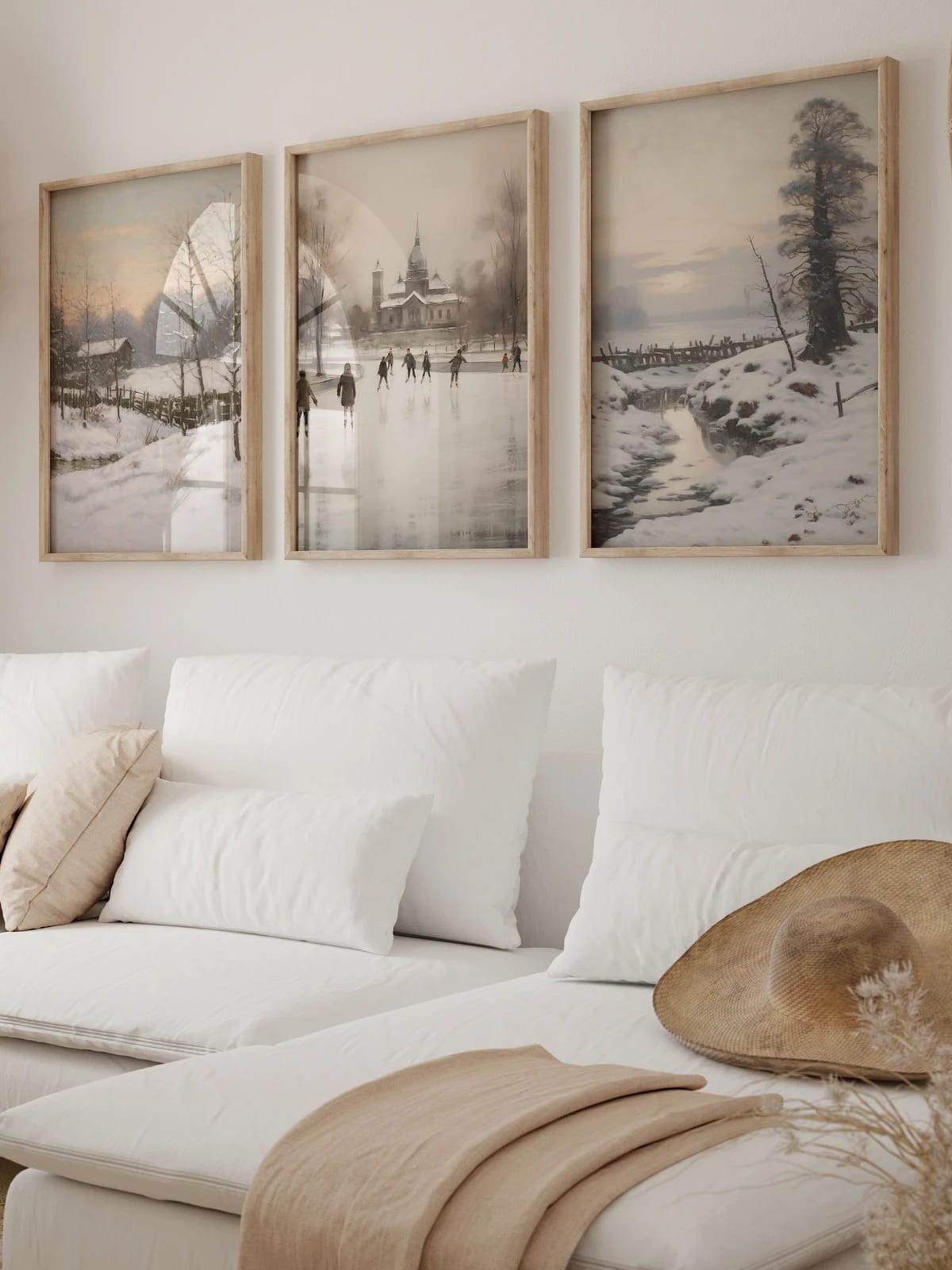 Three winter scenes of a snowy home, skating rink, and stream arranged in a room; frames are not included.