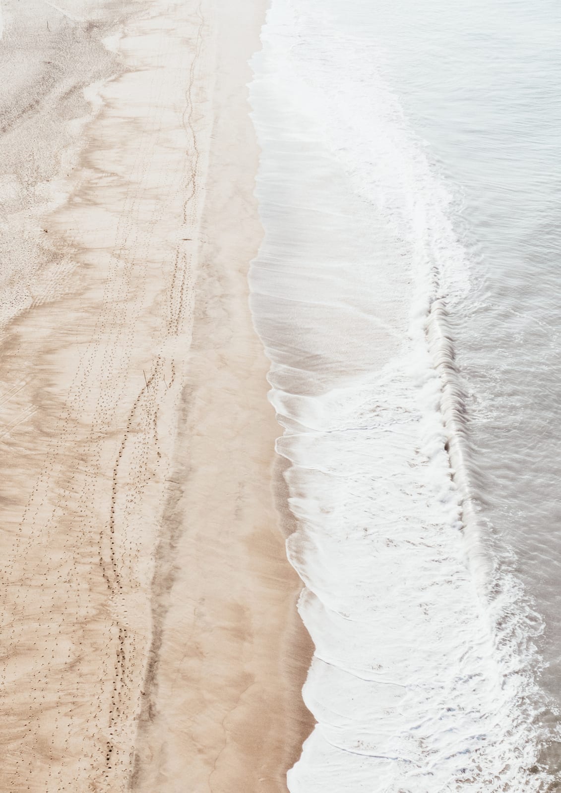 wave at a light sandy shore.