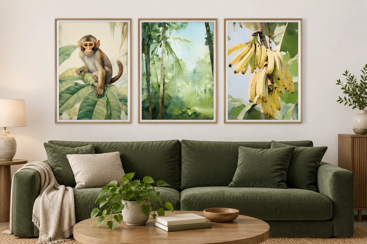 Three green prints above a deep green sofa.