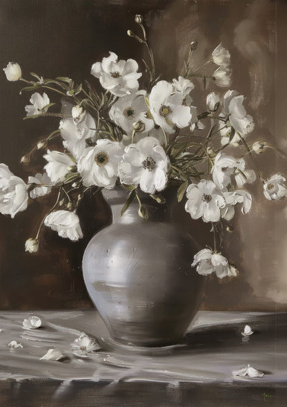 White flowers in a rounded gray vase against a dark background.