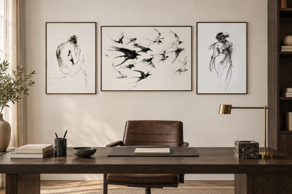Graphic figure and bird prints displayed above an office desk.